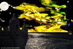 shining night surrealistic landscape with tower,sea,moon and lights in yellow sky