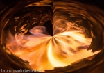 abstract fire vortex in hole with swirling flames