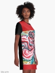 graphic t shirt dress side view with Christmas colors abstract image in tones of red green, white, black and yellow